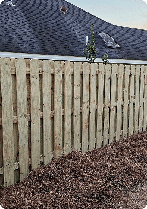 Buying a Fence on Price vs. Buying on Warranty 4 New wooden fence with pine straw