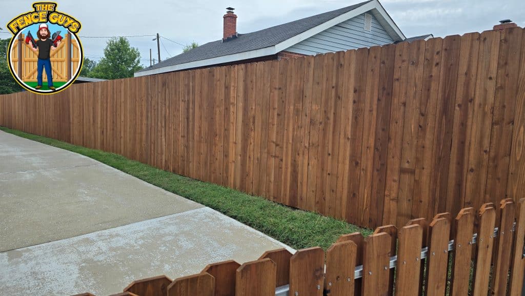 Cedar vs. Pressure-Treated Pine Fence: Which Is Worth It in the CSRA? 5 Wooden fence along a driveway.